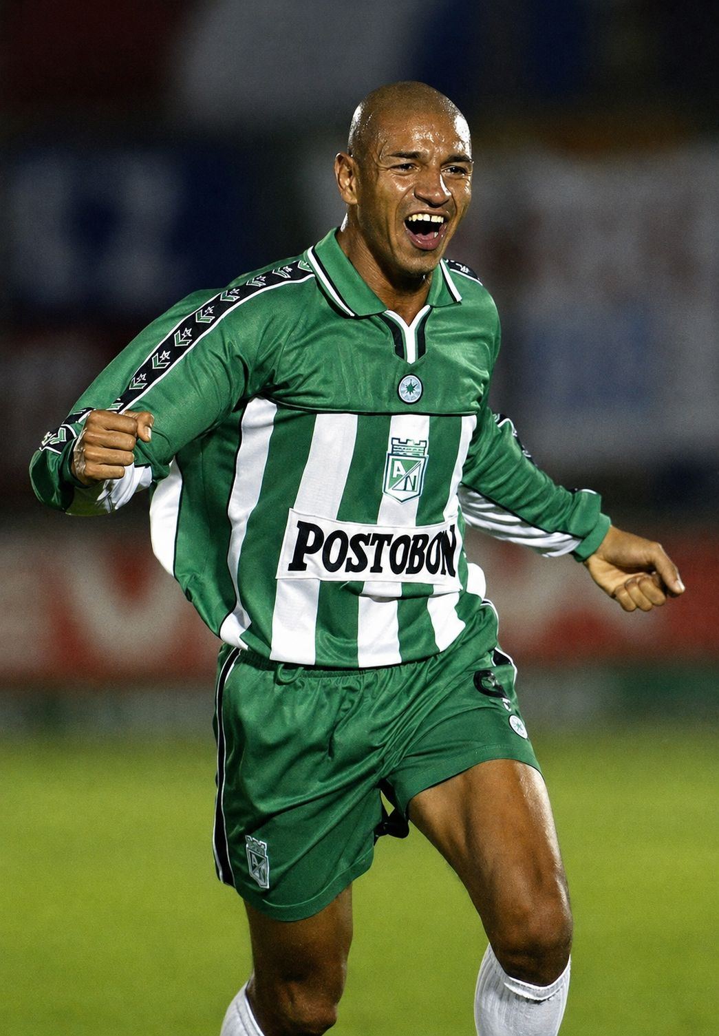 Atlético Nacional player celebrating, green and white stripes, 2001